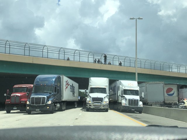Truckers lined up under a Florida highway to save a man who threatened to jump